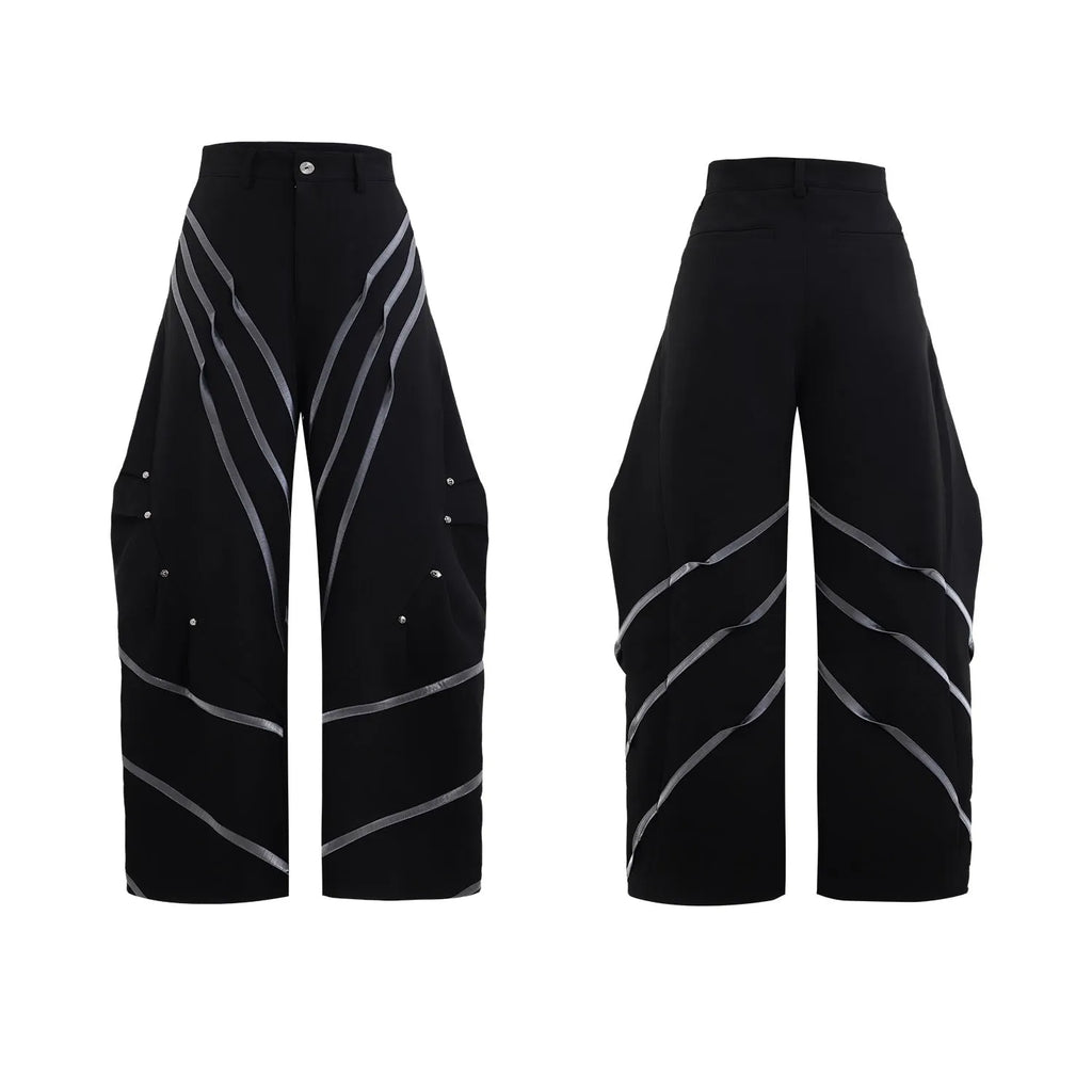 Men's black trousers with metal striped rivets and pleated design detail