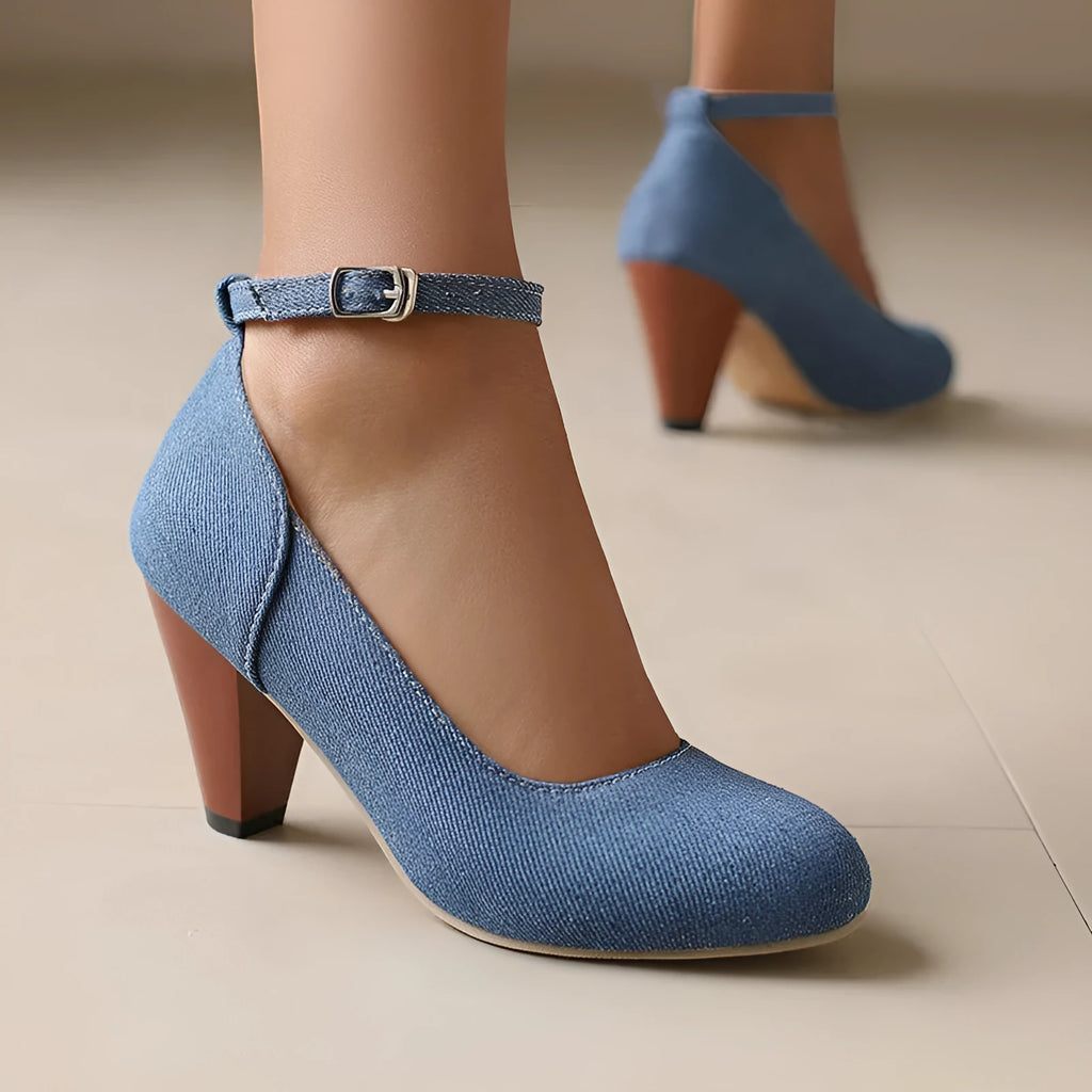 Blue denim women's ankle boots with a buckle strap and thick platform heel on a rubber sole.