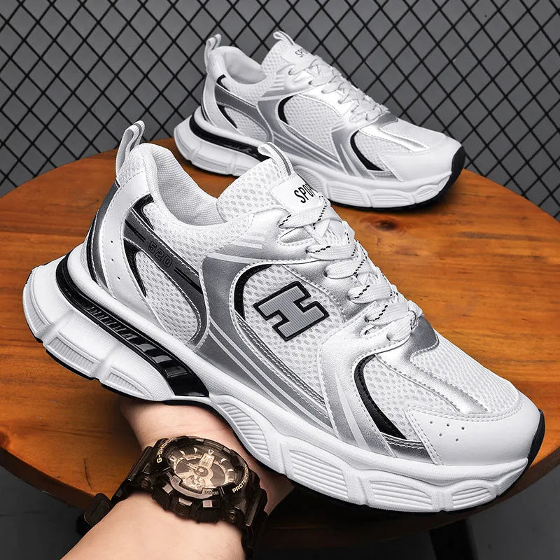 Men's solid colour mesh running shoes with a plastic sole, shown in black, white and grey, and white and orange.