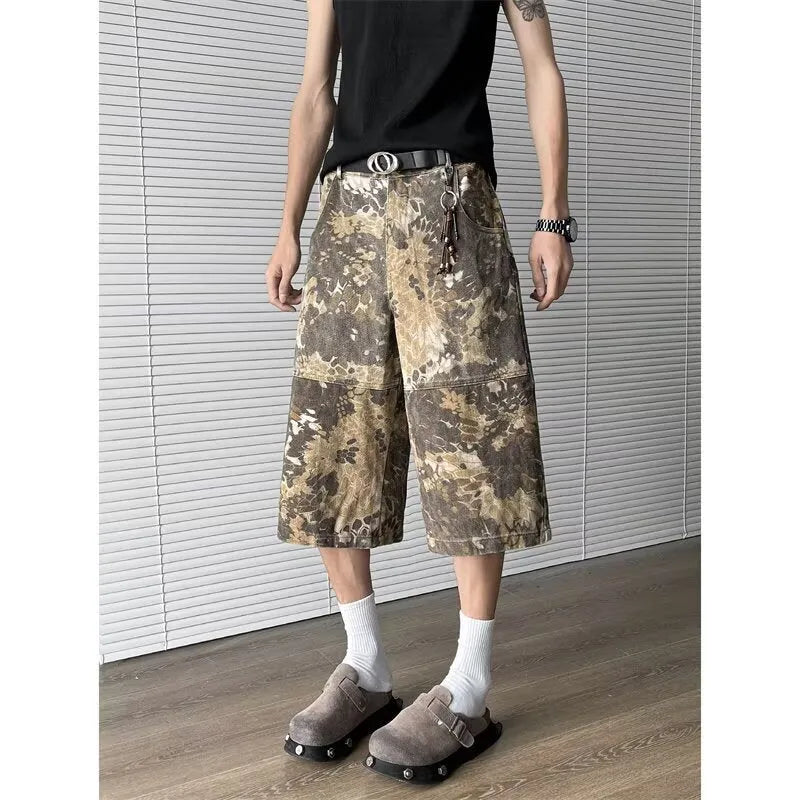 Yellow women's cropped jeans with a bold snake and camouflage pattern print on the legs.