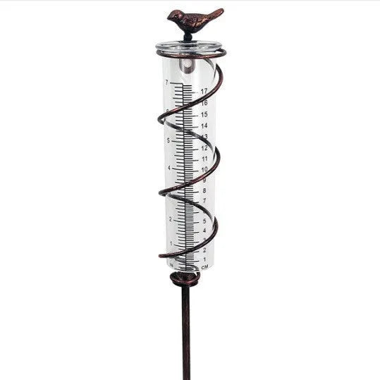 Cast iron garden rain gauge with glass tube and hummingbird decoration, showing 1-20 measurement scale.