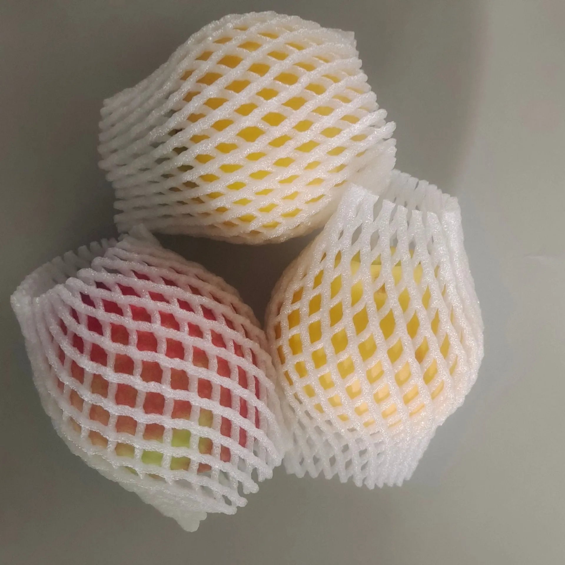White foam protective net sleeve for fruit and delicate items, shown in multiple sizes.