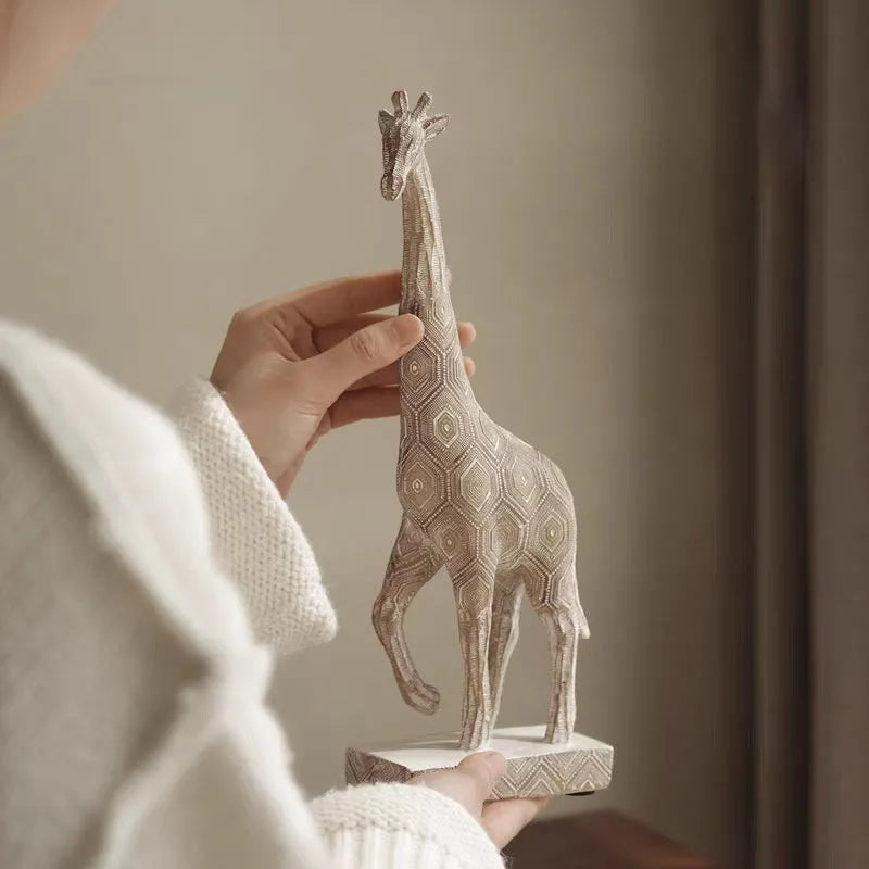 Wood colour giraffe-shaped resin ornament on a shelf, showing European style design.