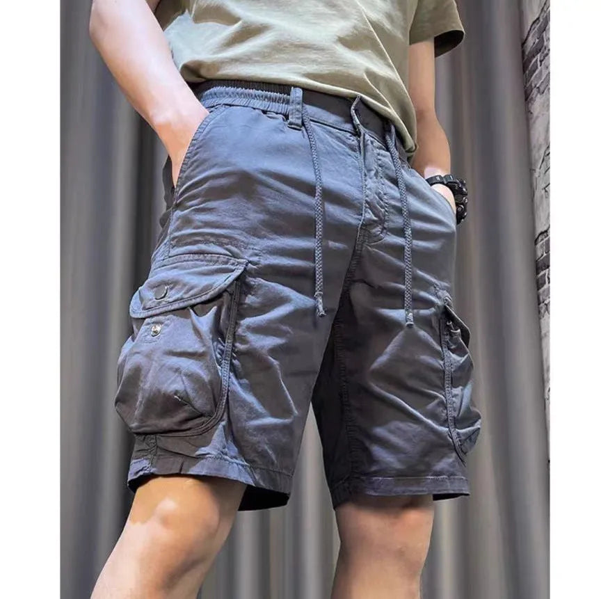 A pair of loose straight leg casual overalls with multiple front pockets, shown in a khaki colour.