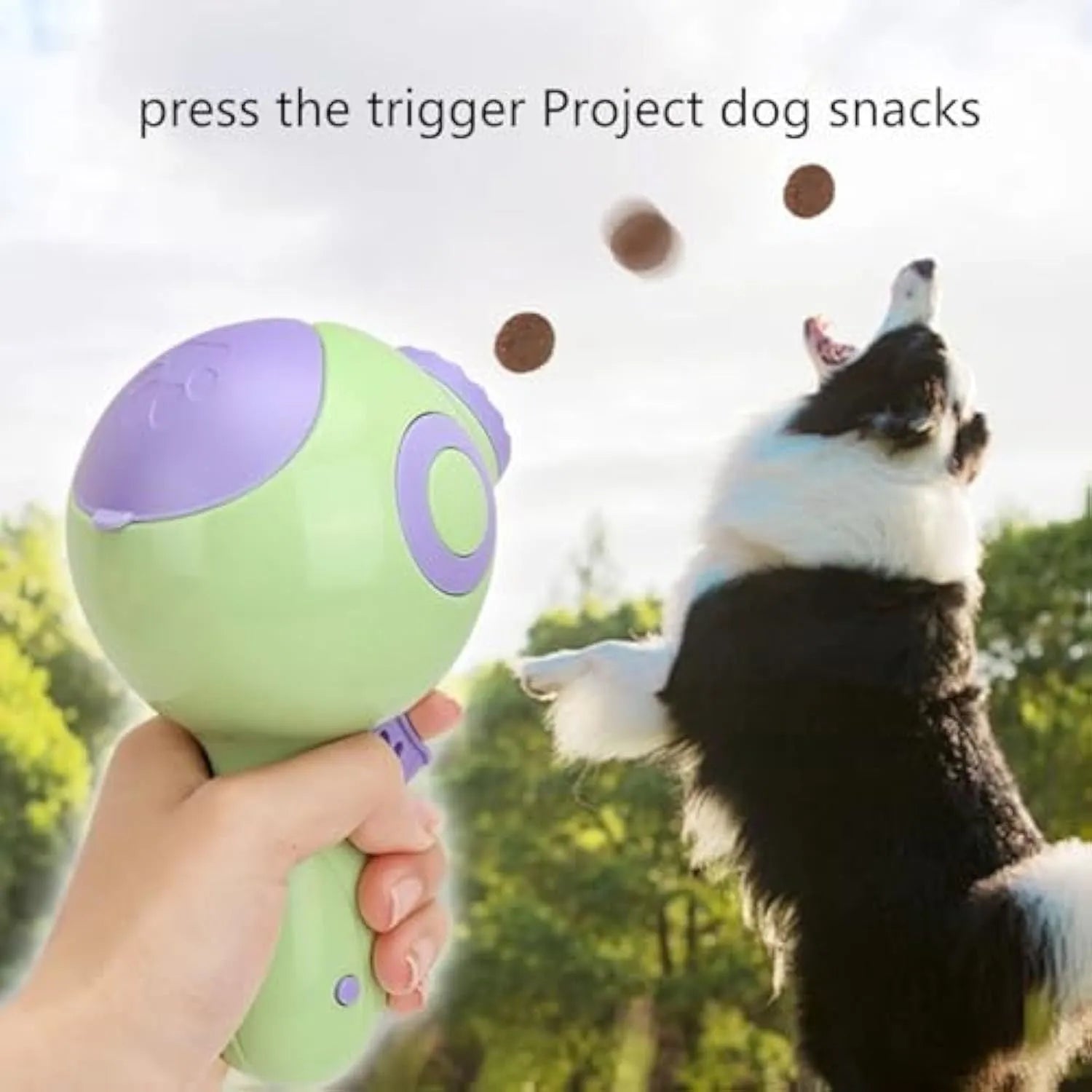 Green, orange, and pink plastic dog treat launcher toy for interactive feeding and training.