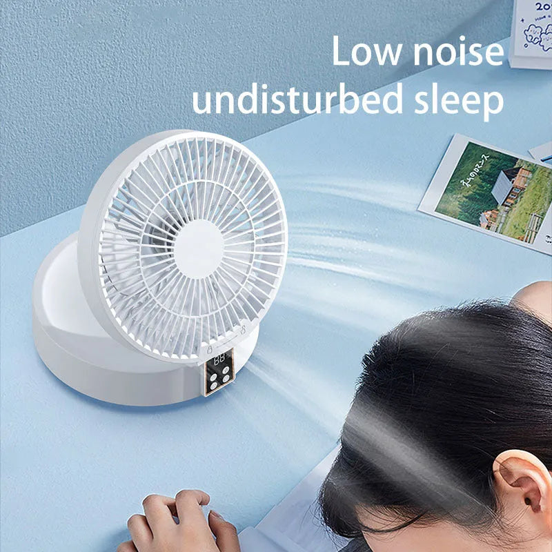White rechargeable folding USB ceiling fan with remote control on wooden desk