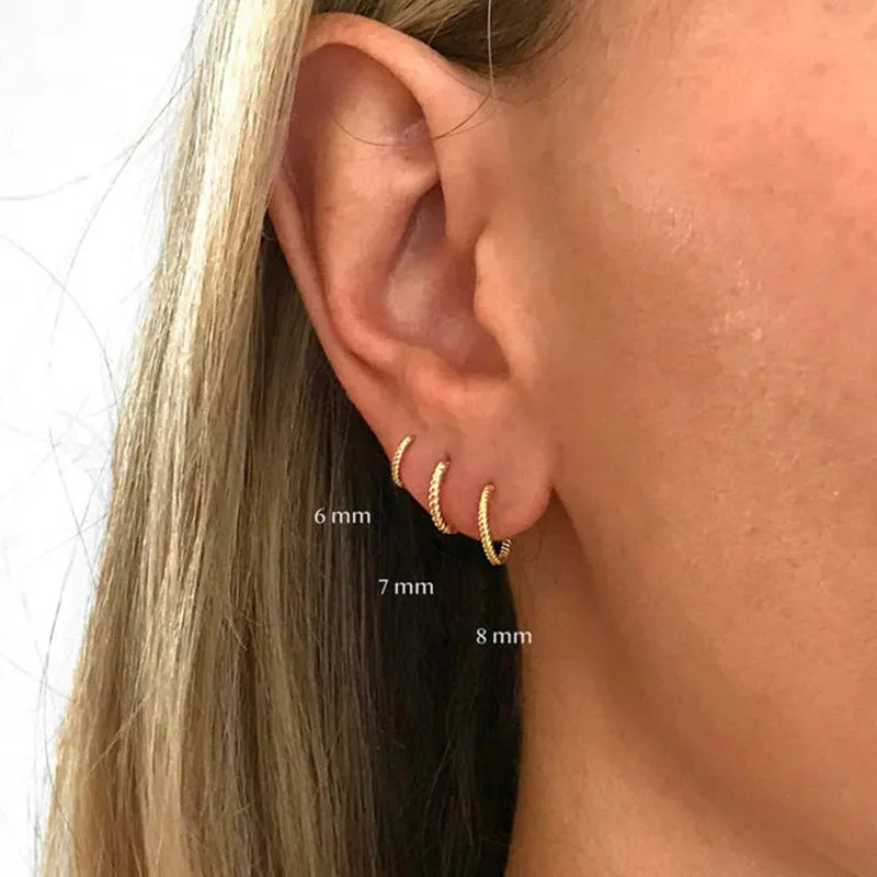 Twisted sterling silver round ring earrings in golden and white gold finishes