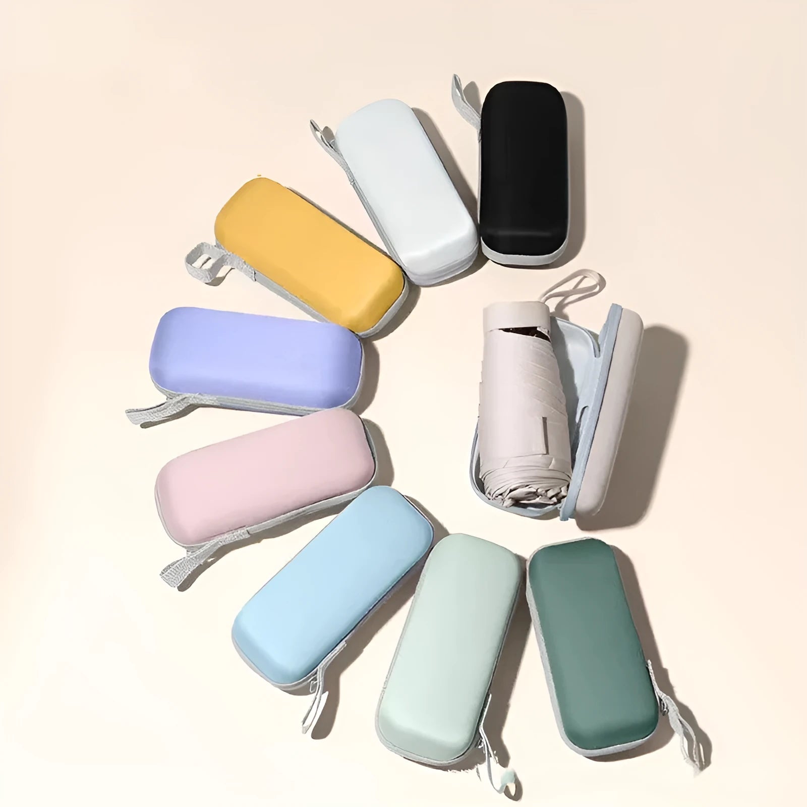 Six-fold manual umbrella in sky blue with capsule box storage, showing compact folded size and rubber handle