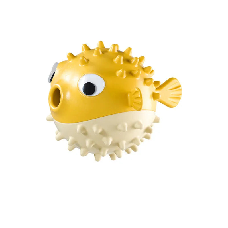Green interactive fish-shaped dog toy with treat dispensing hole and raised cleaning particles