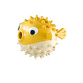 Green interactive fish-shaped dog toy with treat dispensing hole and raised cleaning particles