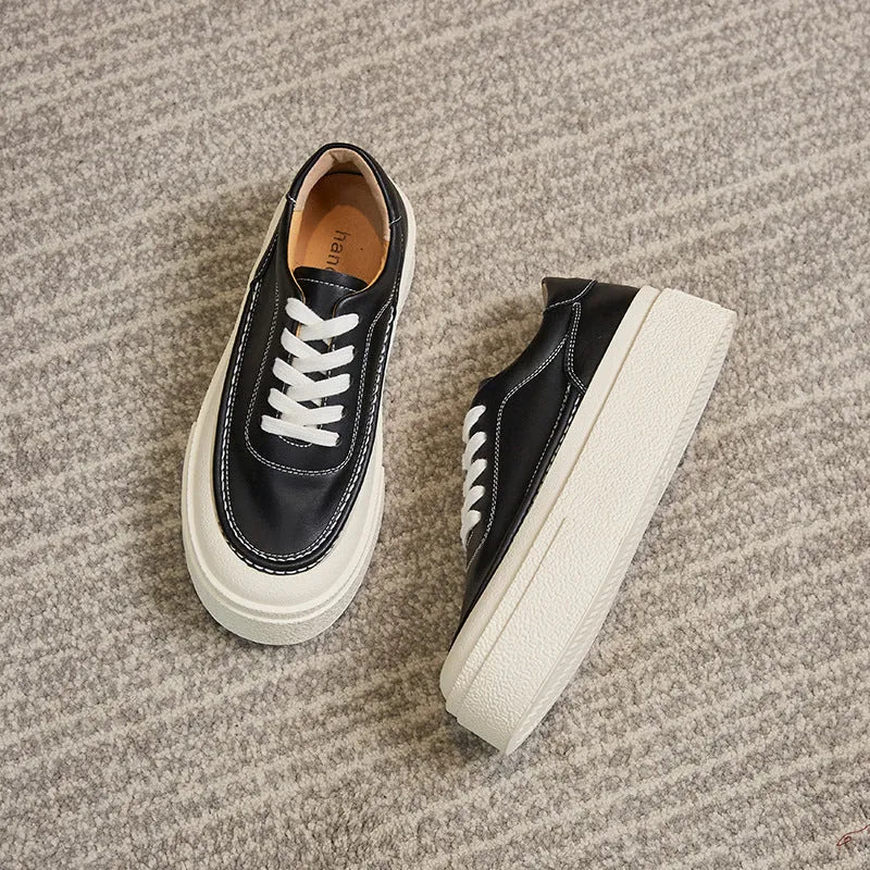 Women's black embossed cowhide leather platform sports board shoes with a round toe and white rubber sole.