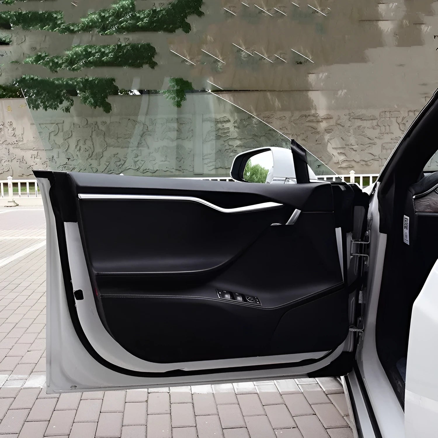 Carbon fibre protective film kit for Tesla Model S doors showing four pre-cut pieces