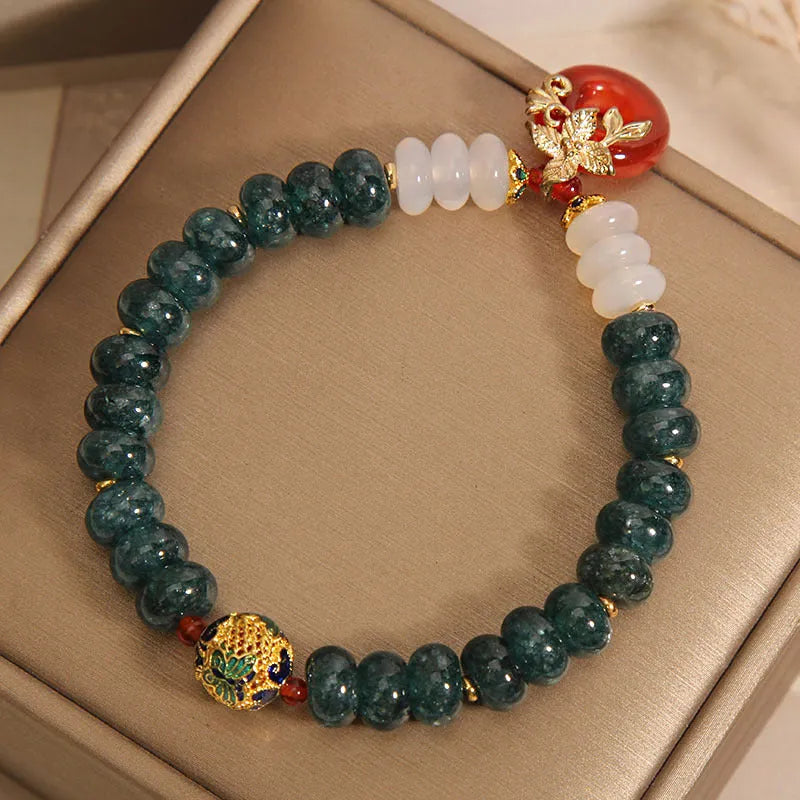 Blue water jade and red agate bracelet with crystal beads and a peace buckle closure