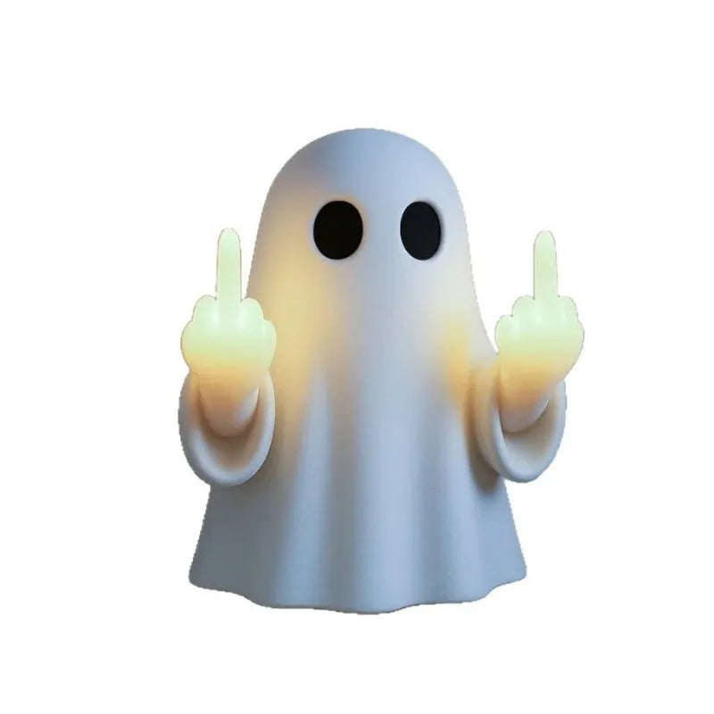 Small white ghost-shaped plastic night lamp for Halloween decoration on a table.