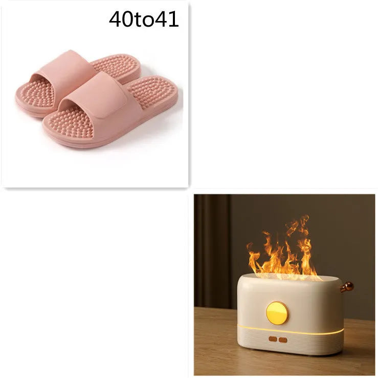 Black USB humidifier with simulated flame effect and water tank on wooden desktop