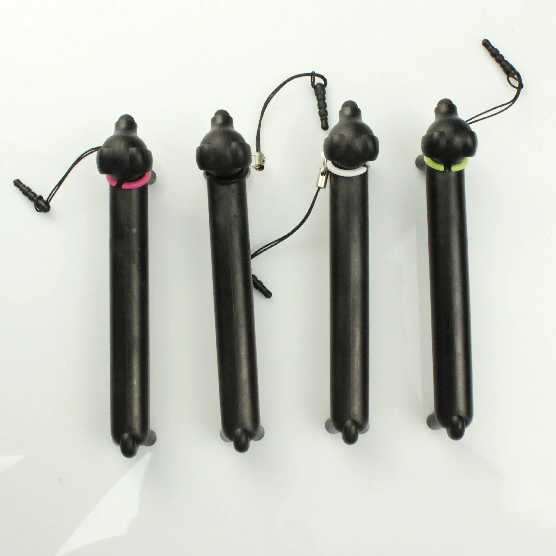 Black dog-shaped touch screen stylus with conductive construction shown next to its carry pouch