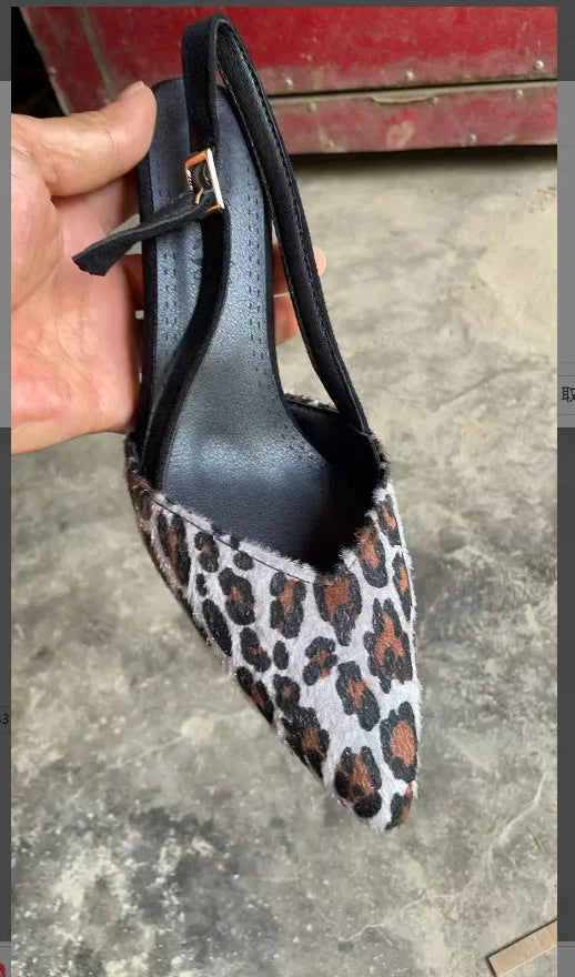 Women's leopard print suede sandals with pointed toe and high heel on size label background.