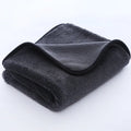 Grey automobile cleaning cloth with black edging showing spiral hair texture and hemmed edges