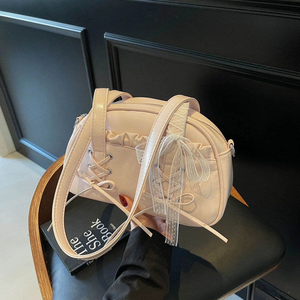 Women's casual shoulder bag in PU leather with a white bandage bow design on the front.