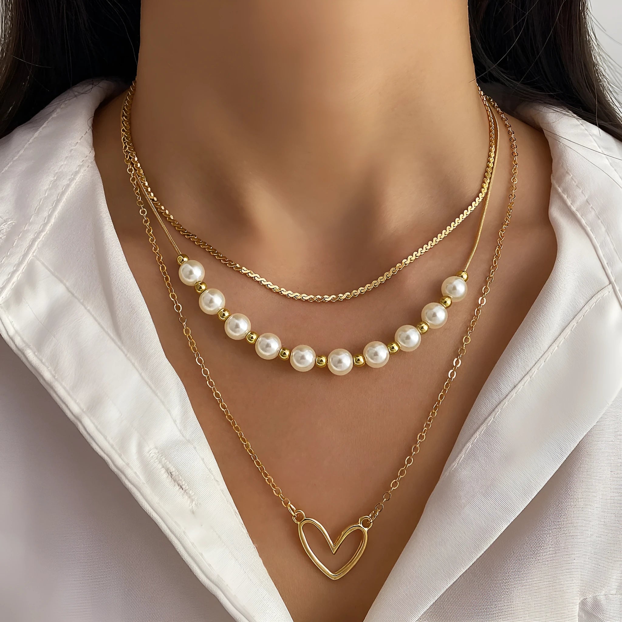 Vintage gold necklace with heart pendant and pearl details on chain