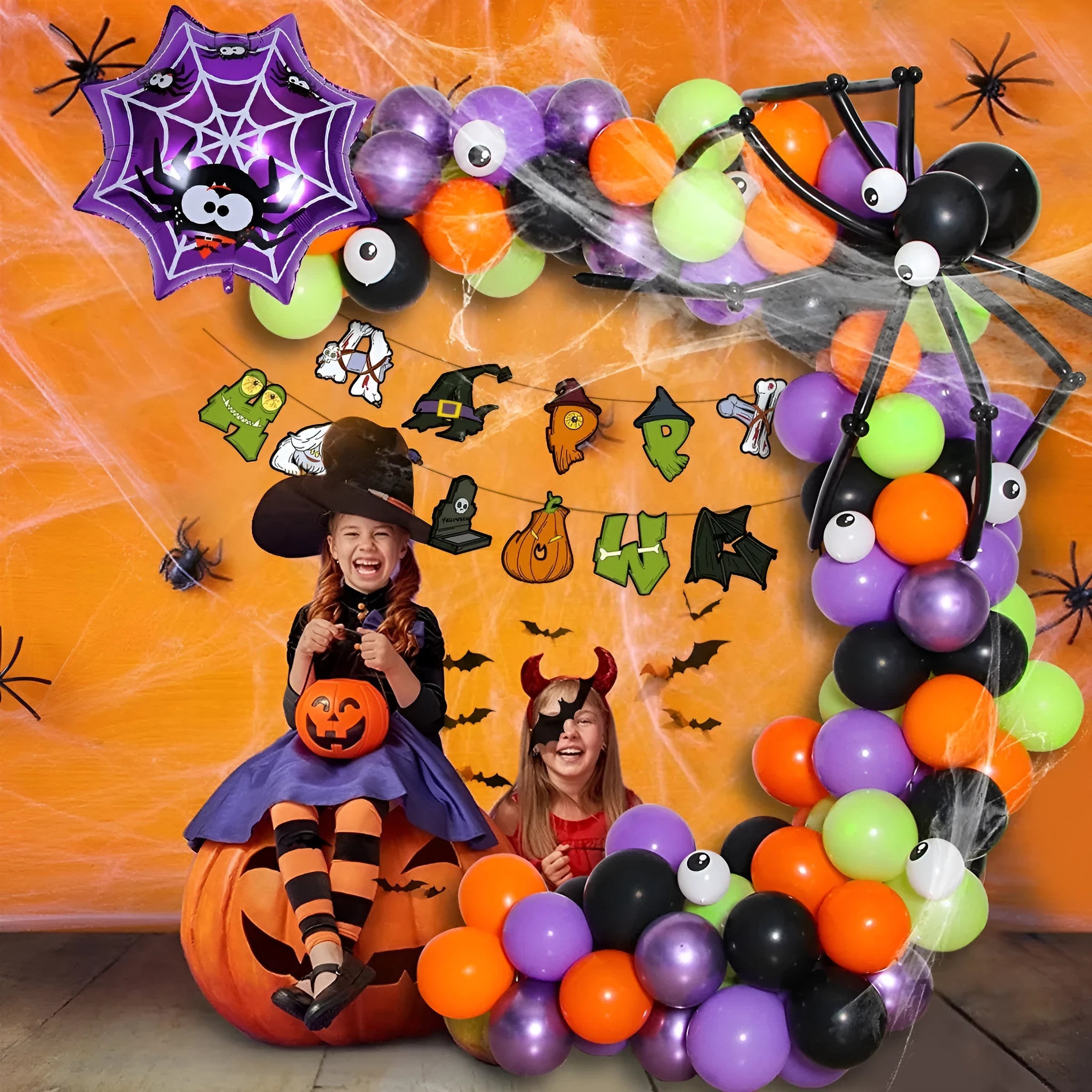 White and black latex Halloween balloons with skull and pumpkin designs for a spider balloon arch.