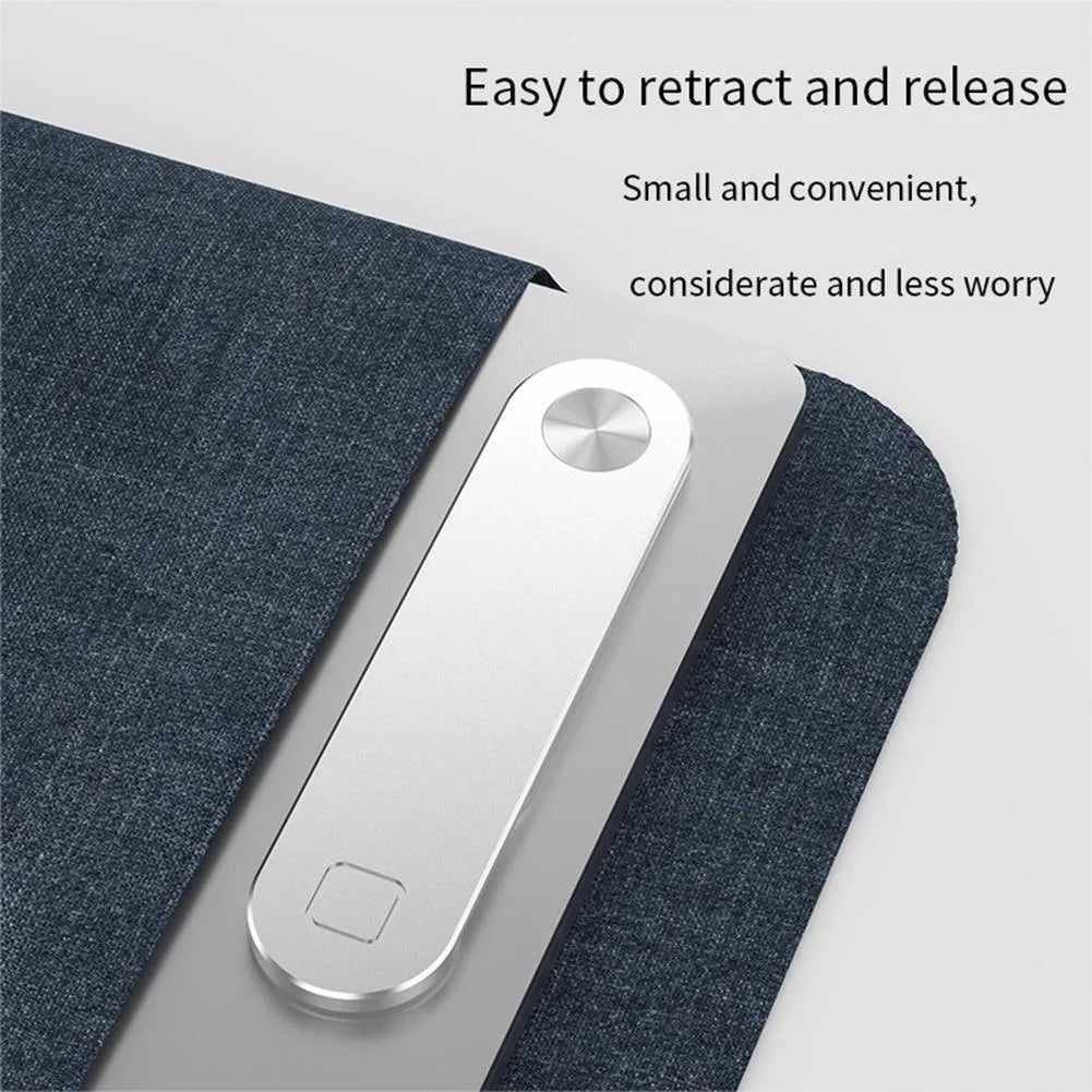 Black magnetic phone holder clipped to the side of a silver laptop, showing a smartphone attached.