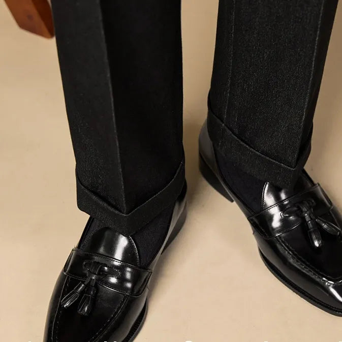 Men's genuine leather tassel loafers in black and brown colours showing polished uppers and rubber soles