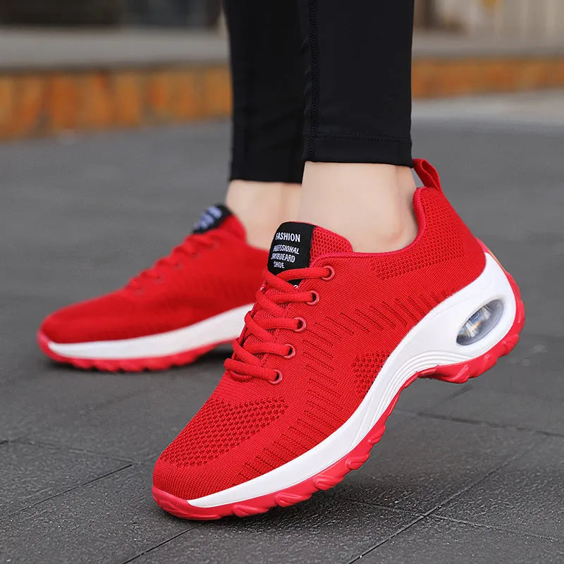 Women's round toe red mesh sneakers with white laces and a platform sole on a white background