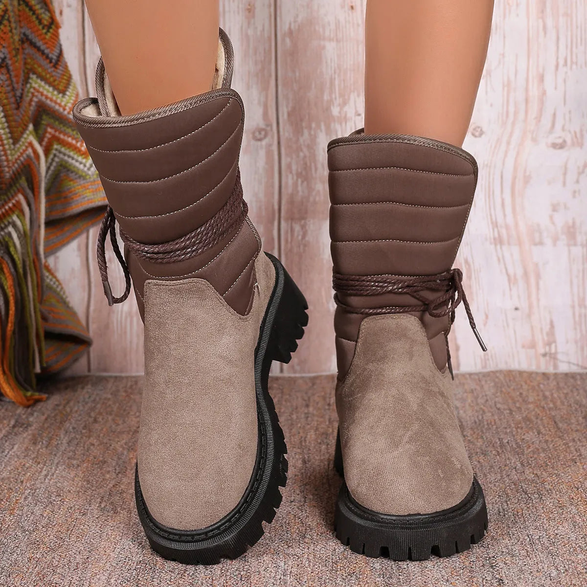 Women's black chunky heel snow boots with lace-up front and fleece lining on a white background.