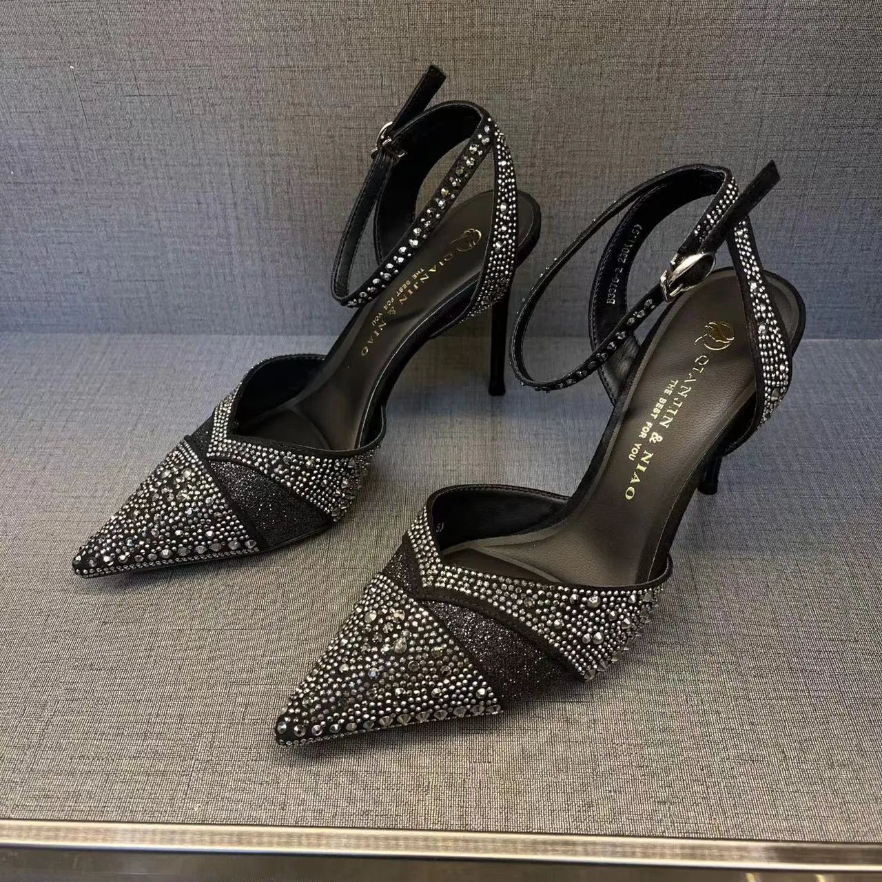 Women's hollow stiletto high heels with red sole and pointed toe design in black and silver options