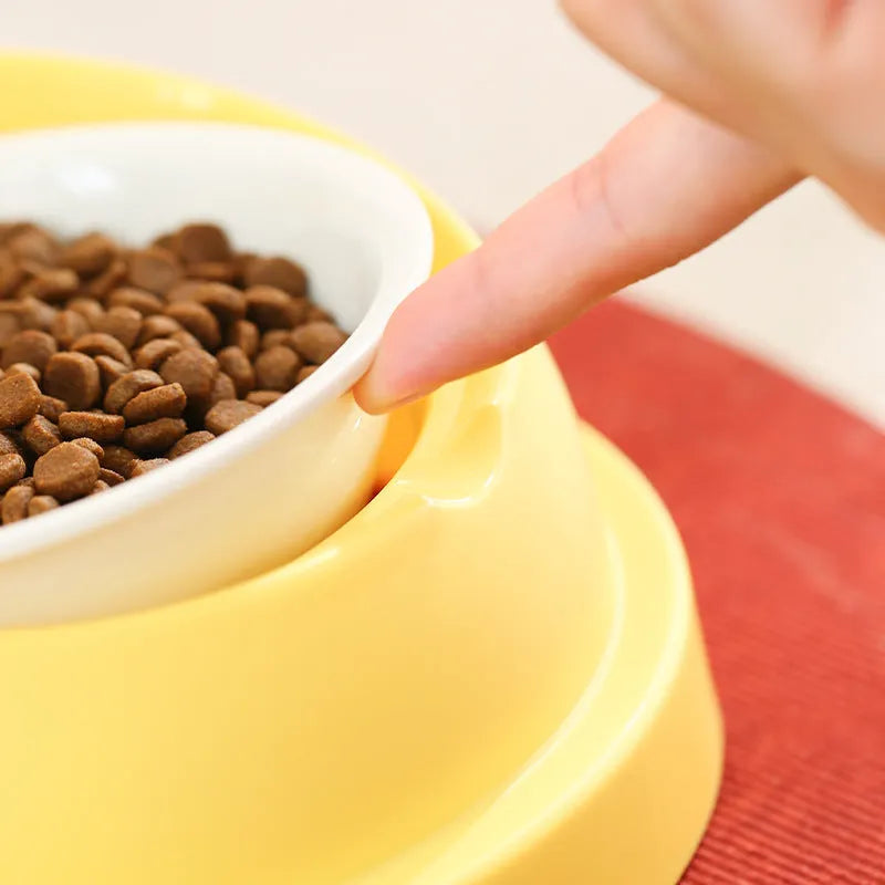 Grey and yellow dual ceramic pet feeding bowl with stainless steel insert and non-slip base.