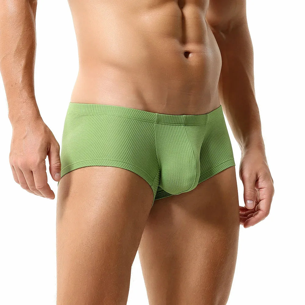 Men's solid colour low waist nylon boxer shorts laid flat, showing orange, blue, green, light blue, and white colour options.