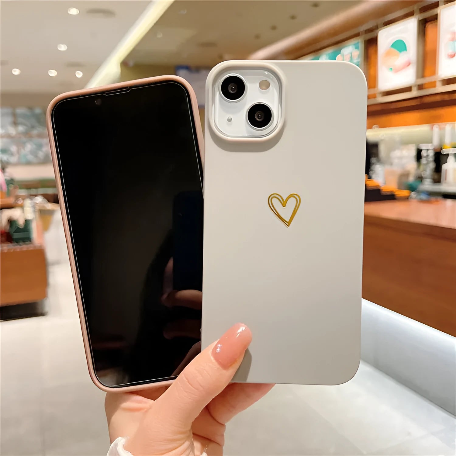 Brown soft silicone iPhone case with a simple cartoon ins style design on a table.