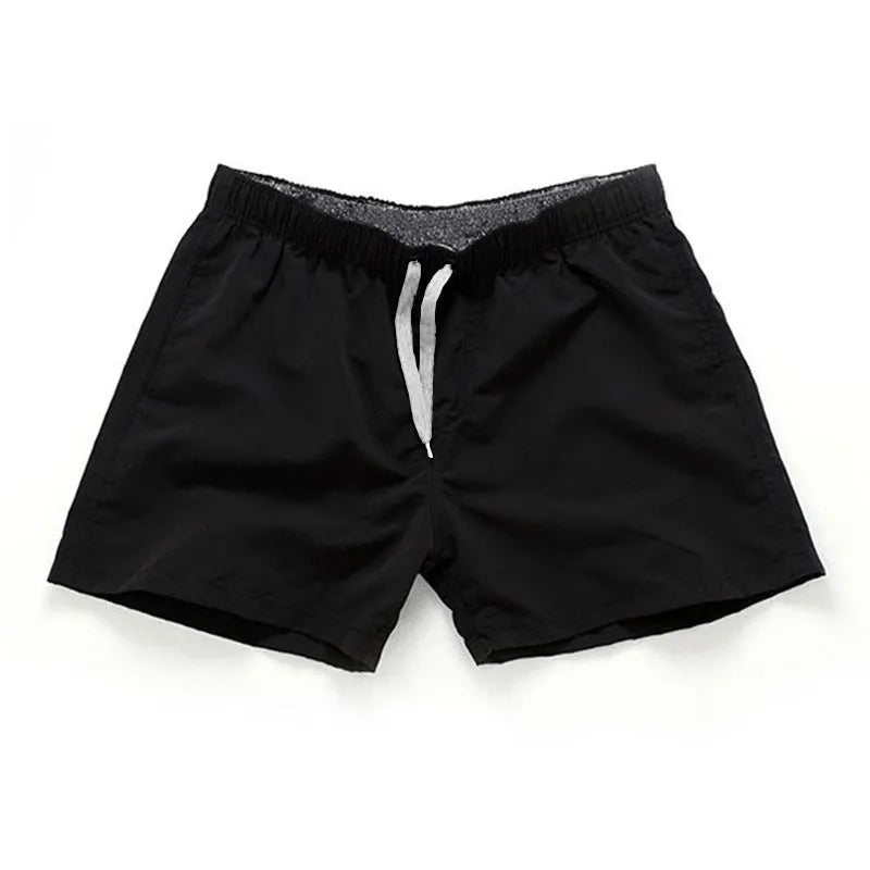 Men's black polyester beach shorts with straight leg opening on a mannequin
