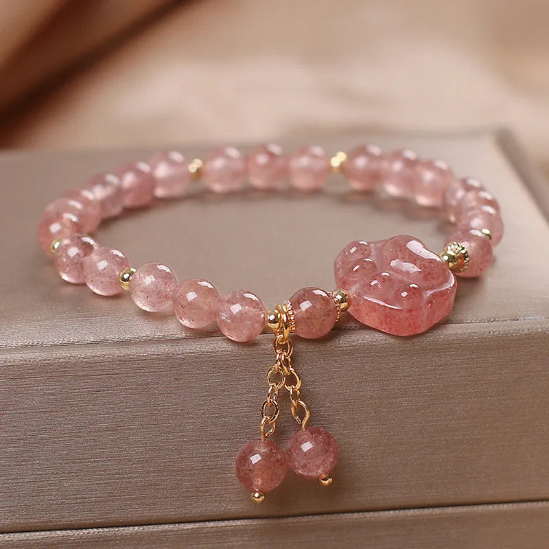 Red double-layer crystal bracelet with Lucky Cat charm and floral beads on wrist