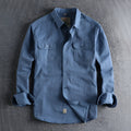 Men's solid colour long sleeve cotton shirt in cardigan style on a hanger.