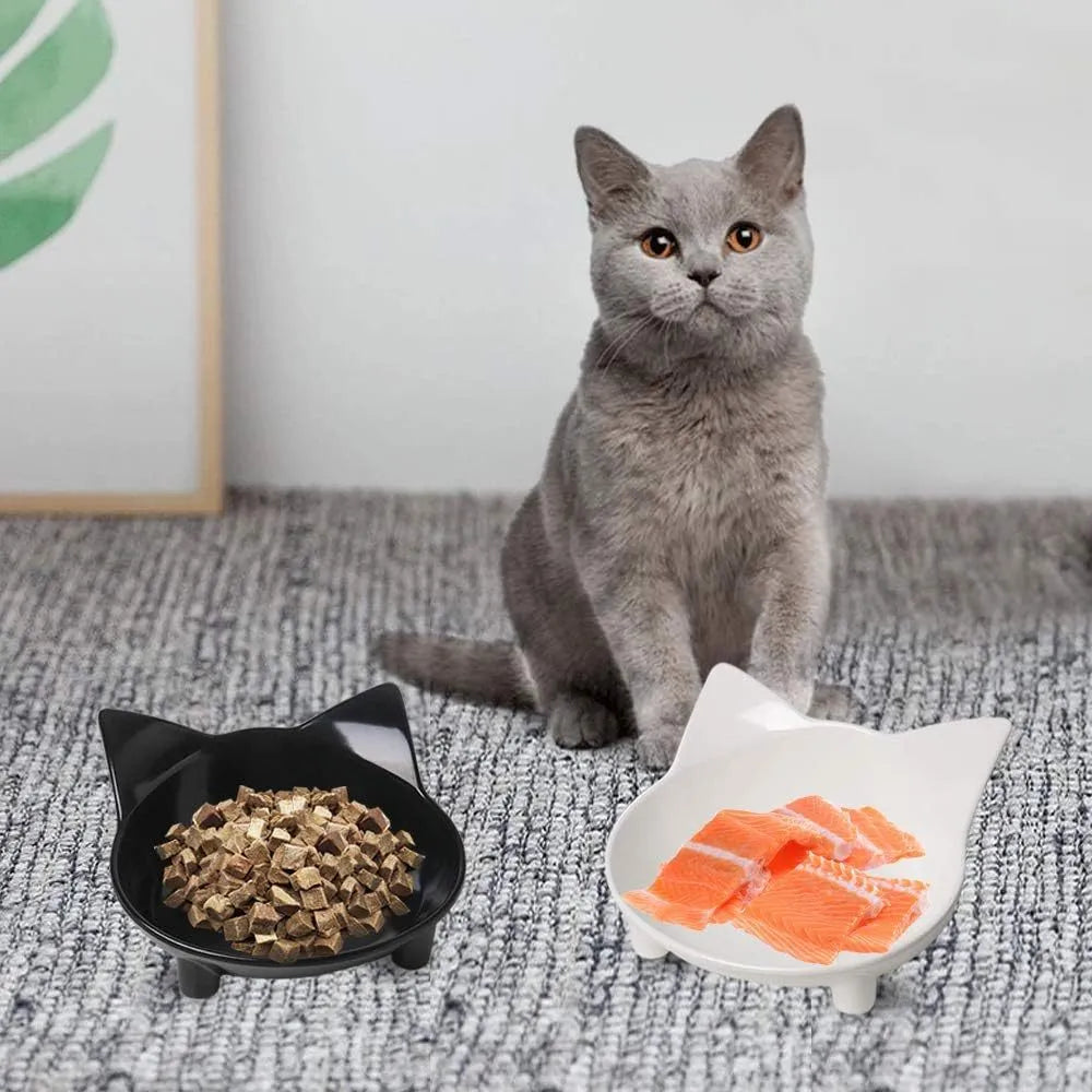 Black shallow melamine pet food bowl with non-slip rubber base on a wooden surface.