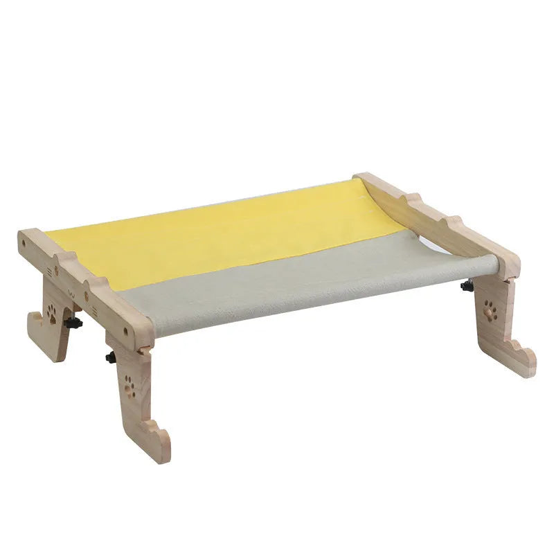 Wooden cat hanging bed hammock shown attached to a balcony railing.