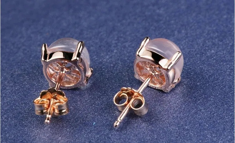 Rose gold coloured drop-shaped stud earrings with a synthetic ross quartz crystal inlay