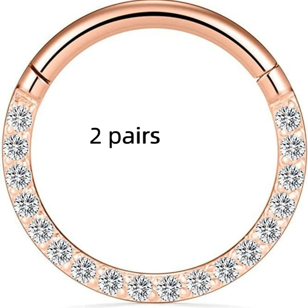 Close-up of a stainless steel seamless nose ring hoop in a gold electroplated finish.