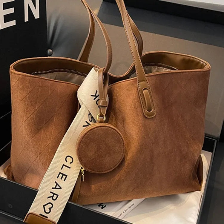 Soft large casual shoulder tote bag in a horizontal square shape with a sandwich pocket and sewing thread detail.