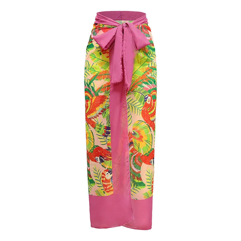 Pink floral retro one-piece swimsuit for women with V-neck and attached skirt on a hanger.
