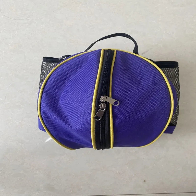 Black Oxford cloth basketball bag with one shoulder strap, shown next to a basketball.