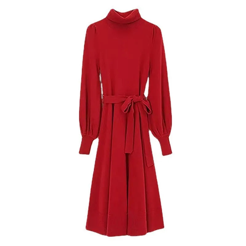 Loose turtleneck knit dress for women with long sleeves, elastic waist, and a big hem in a solid colour.