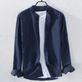 Man wearing a loose fit light blue linen blend long sleeve casual button-down shirt.