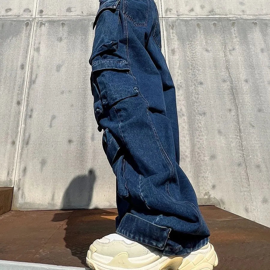 Dark blue distressed wide-leg denim jeans with high waist and multiple pockets laid flat.