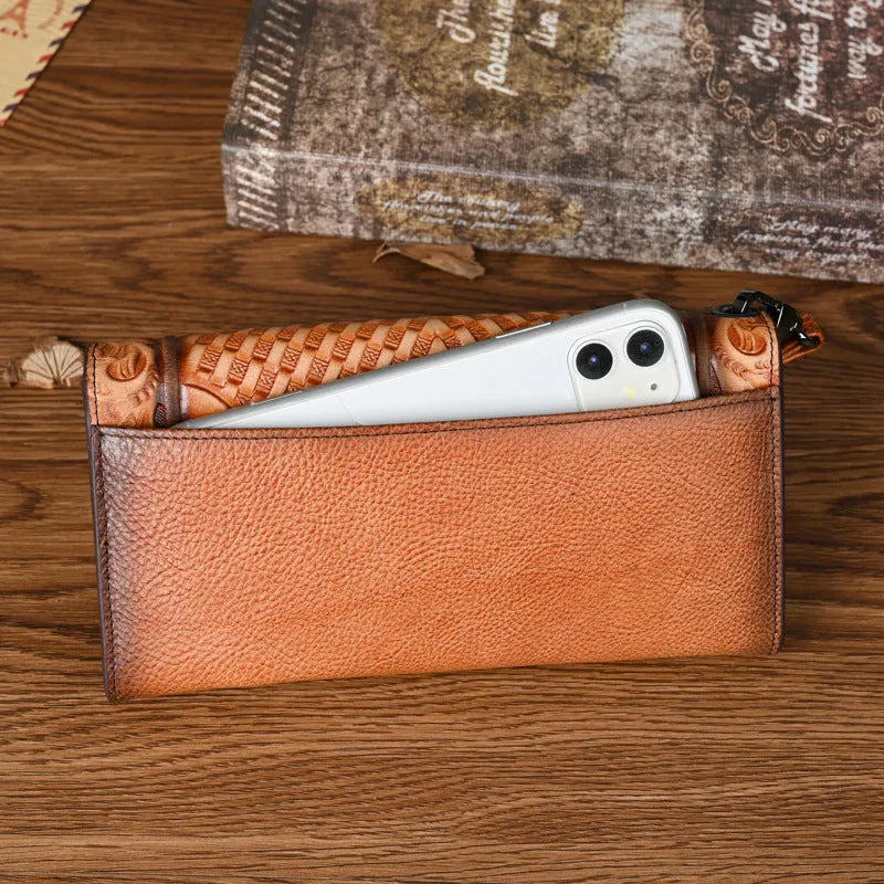 Women's brown tri-fold leather wallet with embossed floral pattern, shown open to reveal compartments.