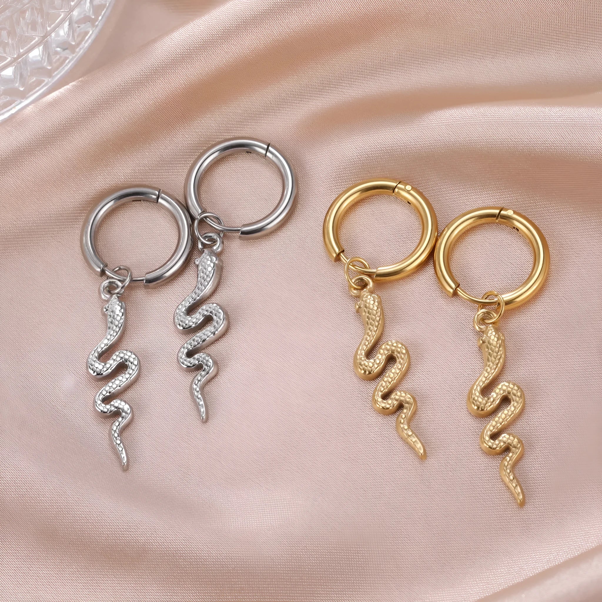 Vintage snake-shaped stainless steel earrings with gold plating in an ear clip design.