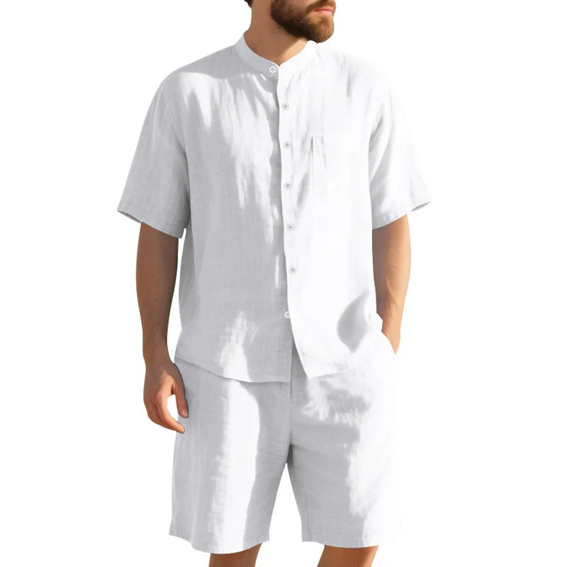 Men's light blue linen blend two-piece suit with short sleeve shirt jacket and shorts on a hanger.