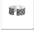 Adjustable opening sterling silver ring with a geometric pattern of several five-pointed stars.